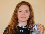 Katie Comeau on a national championship hockey team Beachburg’s Katie Comeau sports her national championship t-shirt and shows the medal she earned as a member of the Liberty Lady Flames university hockey team.
